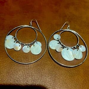 pair of silver tone chandelier earrings with mother-of-pearl style shell discs